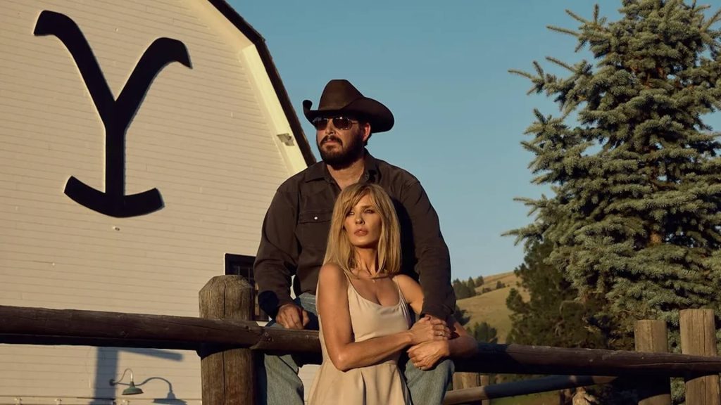 Beth Dutton (Kelly Reilly) and Rip Wheeler (Cole Hauser) looking at the sunset on the farm in 'Yellowstone'