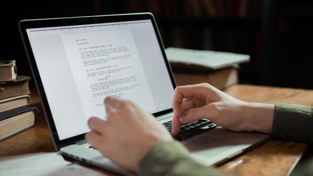 A person typing on a laptop keyboard