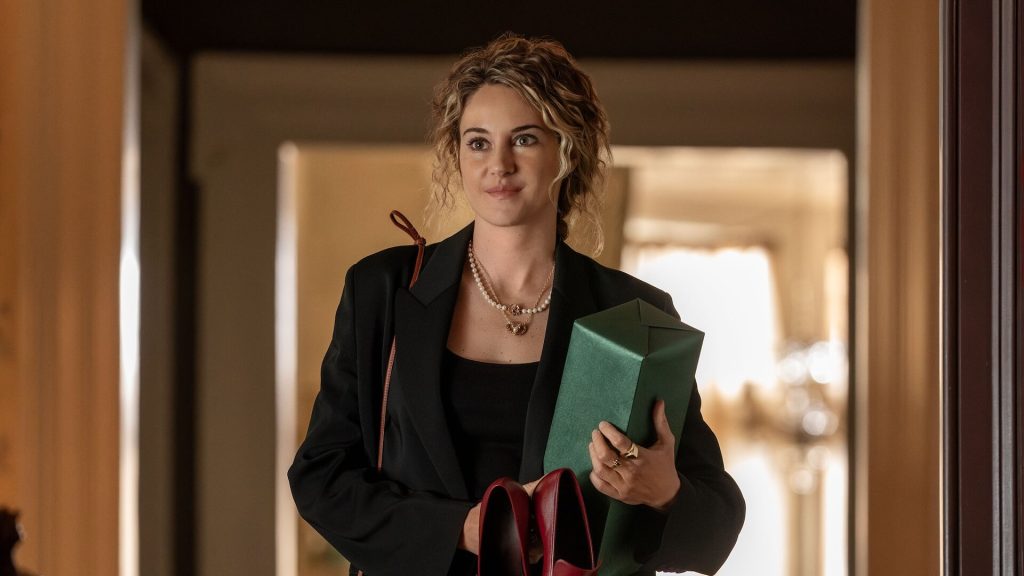 Gia (Shailene Woodley) holding a gift-wrapped box in an office in 'Three Women,' 'Three Women' Writer Lisa Taddeo Offers 3 Writing Insights Every Aspiring TV Writer Should Know