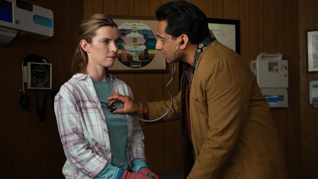 Lena (Betty Gilpin) is examined by a doctor in 