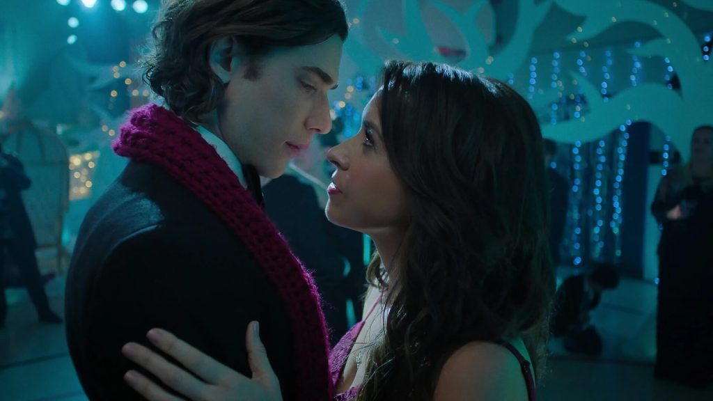 Dustin Milligan as Jack Snowman and Lacey Chabert as Kathy Barrett leaned in for a kiss while dancing.