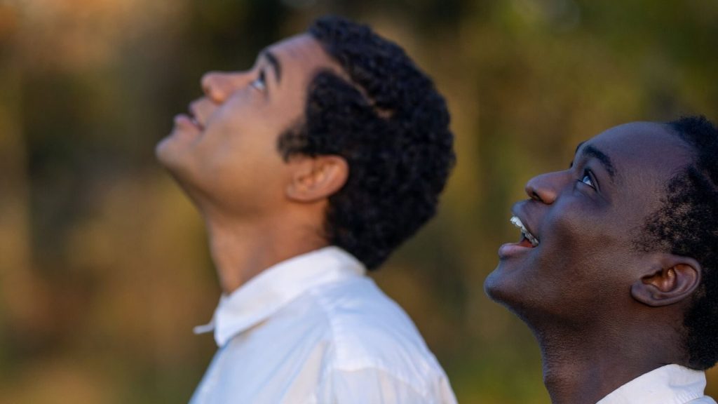 Elwood (Ethan Herisse) and Turner (Brandon Wilson) looking up to the sky. 