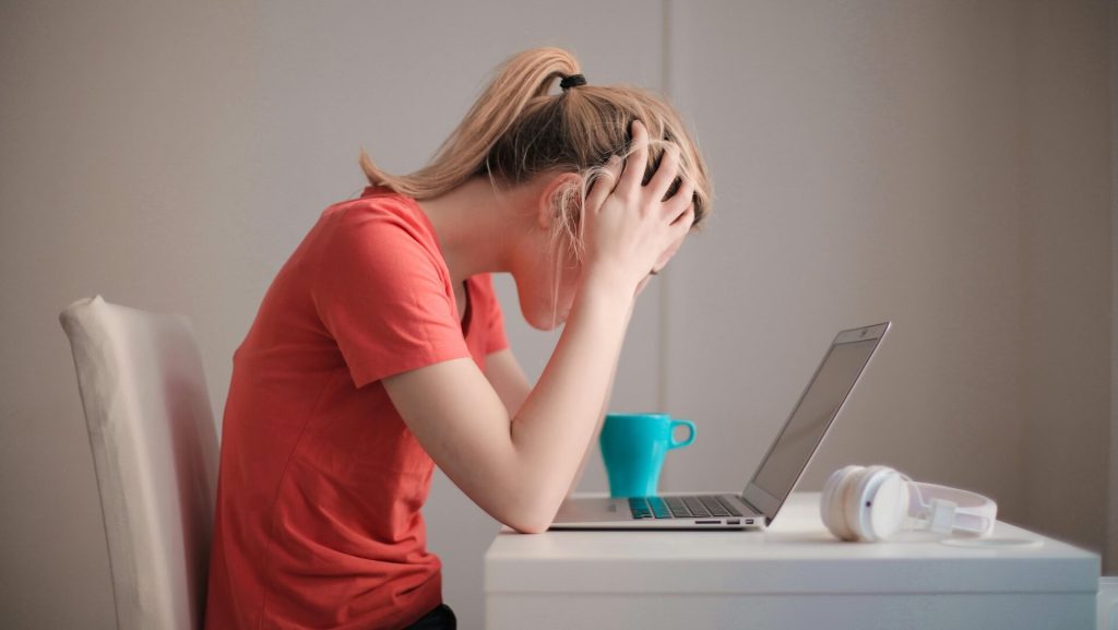 Woman reading off her laptop