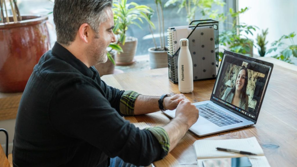 A man sitting in front of a computer chatting with a woman through video chat; How to Be a Pro Screenwriter Without Representation