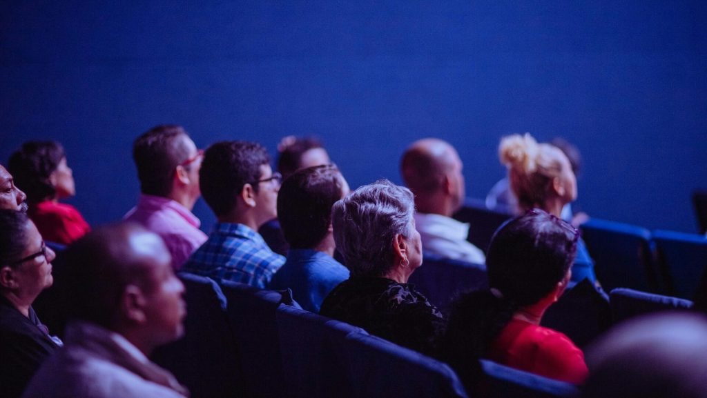 A group of people sitting in a theater